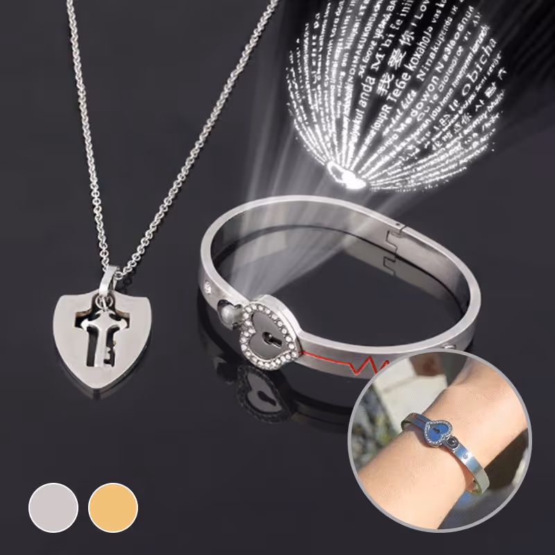 Lock Bracelet and Key Necklace Set — elegant silver-toned jewelry displayed on a soft fabric background
